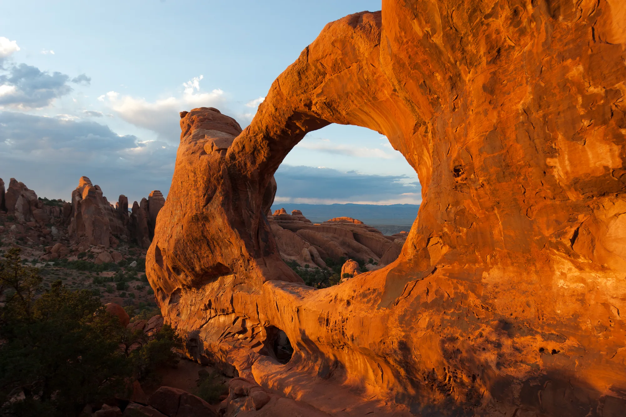 A sandstone arch formation against a desert sky in Arches National Park, Utah