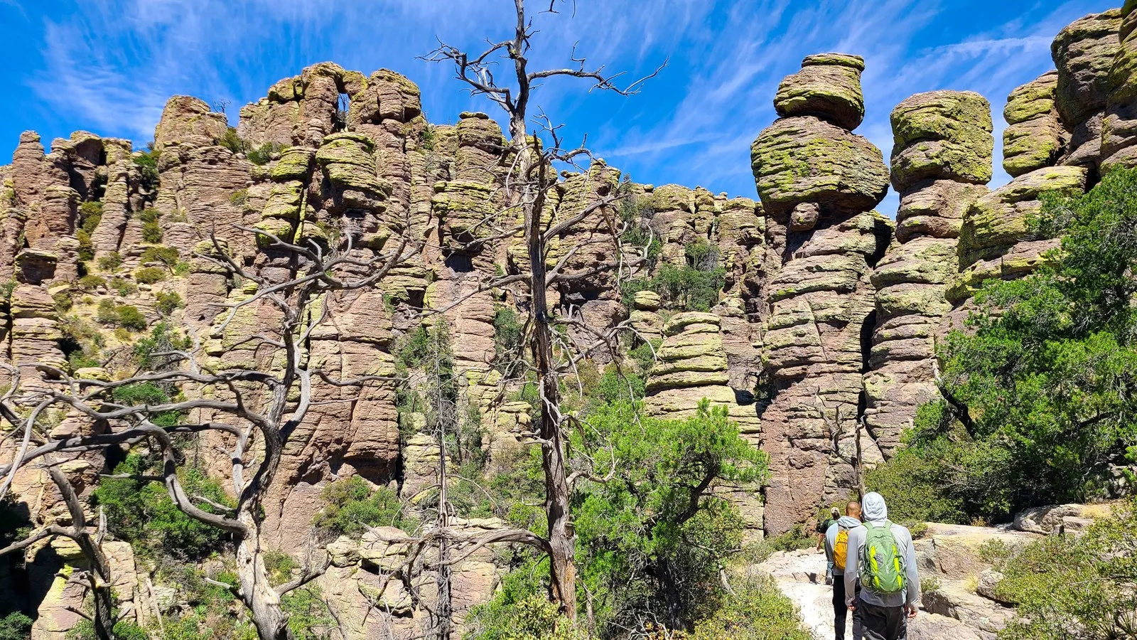 Hikers walking among rhyolite pinnacles in Chiricahua National Park, the 64th U.S. national park